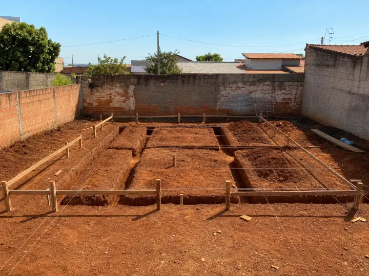 Terreno de uma casa térrea com marcação e estacas para o início da obra.